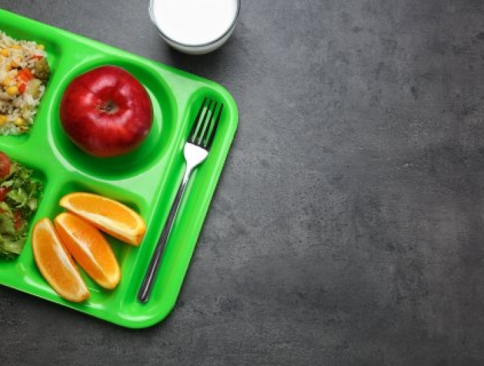A lunch tray with fruit and vegetables